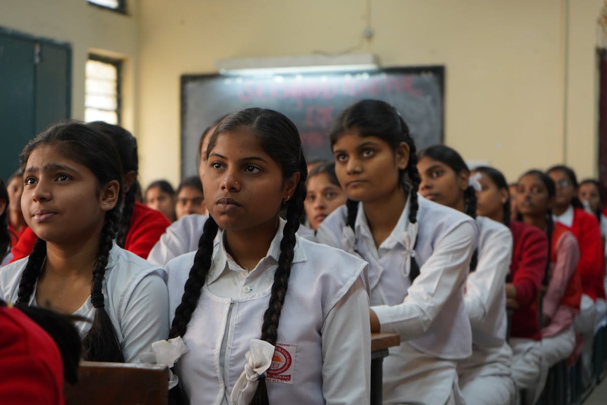 Indian schoolgirls listening carefully in a classroom.