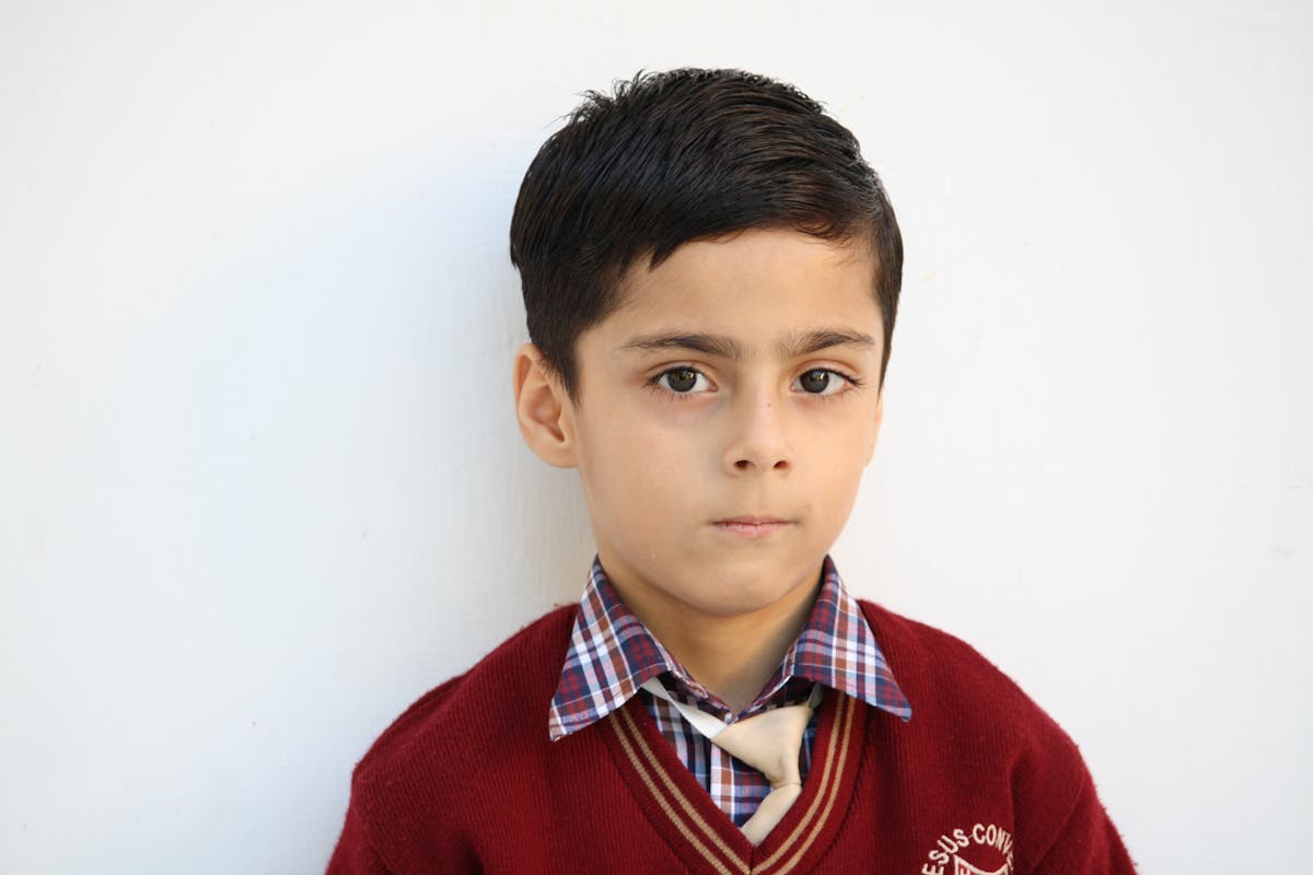 Portrait of a young Indian student in school uniform.